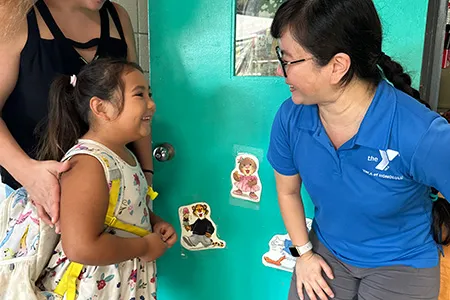 preschool teacher greeting student
